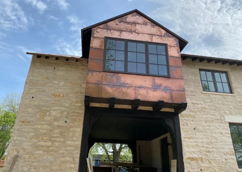 Copper metal panel facade on a stone building for Roof Repair in Oro Valley
